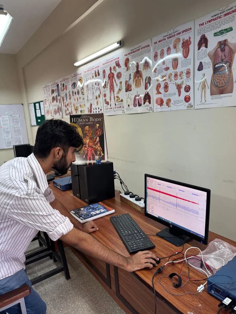 Kaif working at a workstation in the biomedical engineering lab